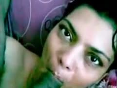 An Indian woman with a solemn, wet appearance gently sucked a black cock.
